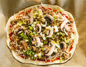 Sausage Mushroom Leek Pizza with Arugula and Fig Balsamic Reduction