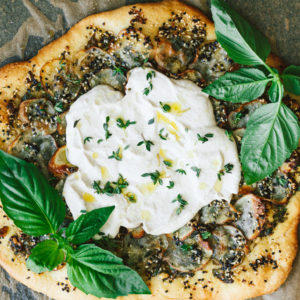 Vegan Potato and Pesto Pizza Topped with Crème Fraîche and Micro Greens