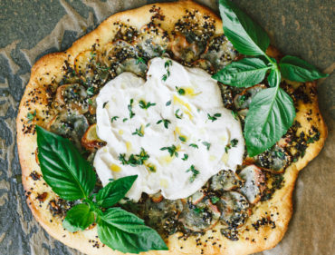 Vegan Potato and Pesto Pizza Topped with Crème Fraîche and Micro Greens