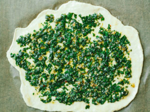 Vegan Potato and Pesto Pizza Topped with Crème Fraîche and Micro Greens
