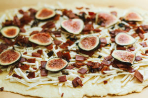 Fig, Bacon, Cashew Chive Cheese with Arugula and a Fig Balsamic Glaze