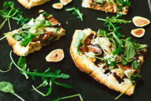 Fig, Bacon, Cashew Chive Cheese with Arugula and a Fig Balsamic Glaze