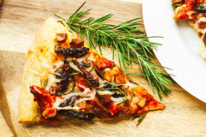Roasted Red Pepper Vegan Chicken, Tofu Bacon, Mushroom, Sun Dried Tomato Pizza, and Fresh Rosemary Leaves with Herbed Crust