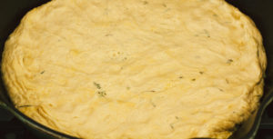Crispy Seasoned Potato Pesto Pizza with Cashew Mozzarella Cream and Arugula on an Herbed Crust