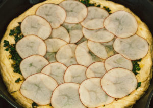 Crispy Seasoned Potato Pesto Pizza with Cashew Mozzarella Cream and Arugula on an Herbed Crust