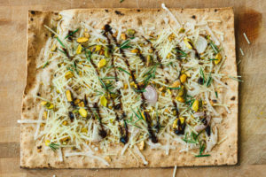 Pistachio, Rosemary, and Shallot Lavash Pizza with Balsamic Reduction