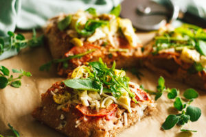 Salami, Artichoke, and Green Olive Pizza with Arugula on Focaccia