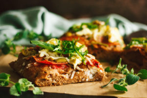 Salami, Artichoke, and Green Olive Pizza with Arugula on Focaccia