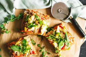 Salami, Artichoke, and Green Olive Pizza with Arugula on Focaccia