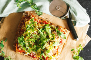 Salami, Artichoke, and Green Olive Pizza with Arugula on Focaccia